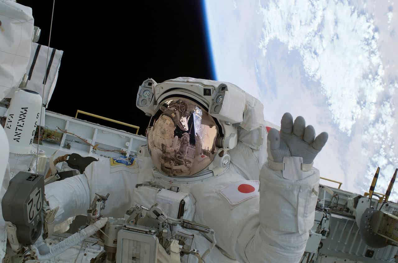 astronaut in space waving