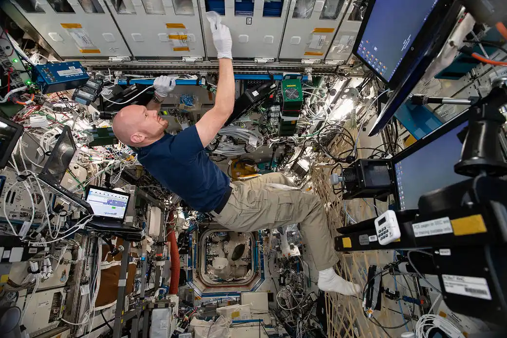 astronaut Alexander Gerst scrubbing the ISS interior