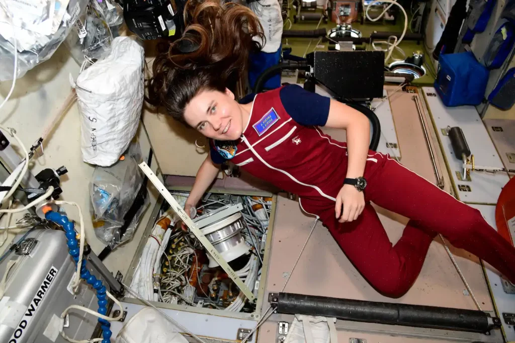 astronaut performing maintenance tasks on iss