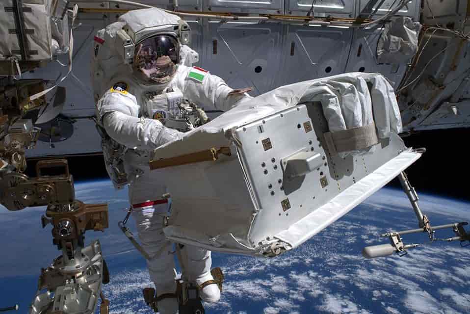 astronaut carrying large box during EVA