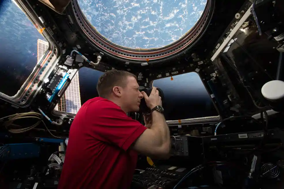 astronaut using personal camera in space