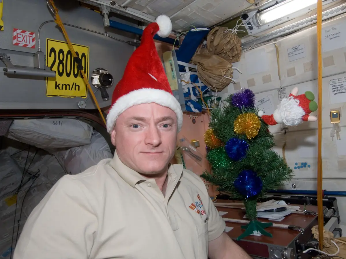 astronaut kelly wearing santa hat
