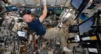 astronaut Alexander Gerst scrubbing the ISS interior