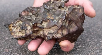 iron meteorite held in hand