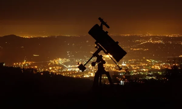 telescope above city and light pollution